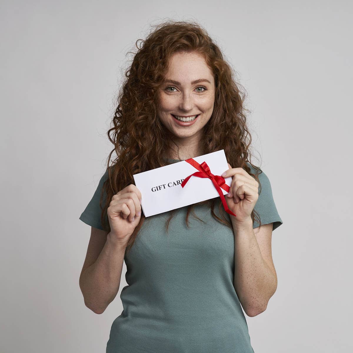 Happy woman holding gift card